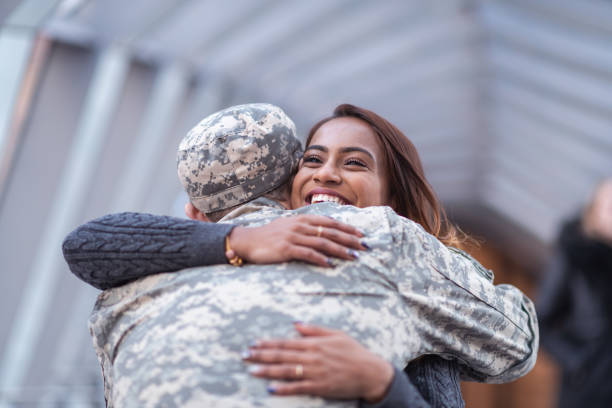 istock Woman hugging her partner after returning home from service 1136917497