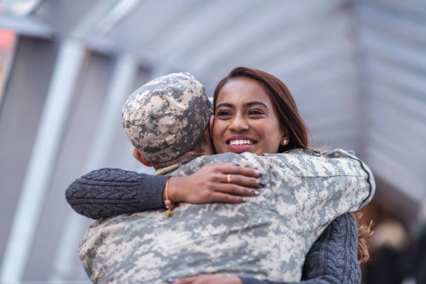 istock Woman hugging her partner after returning home from service 1136917498