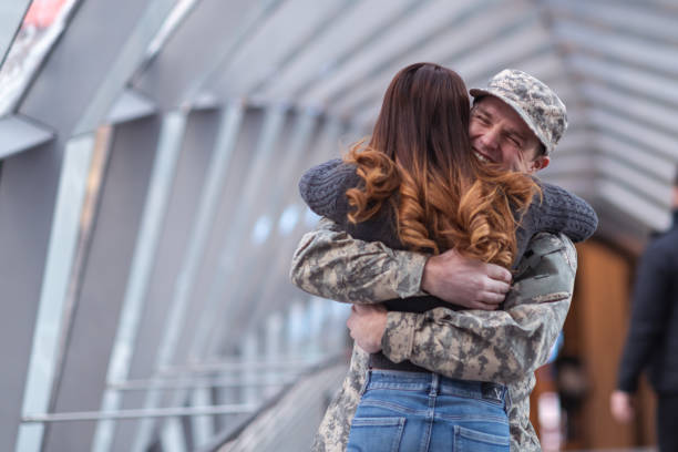 istock Woman hugging her partner after returning home from service 1136917503