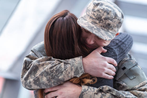 istock Man hugging his wife after returning home from service 1136917504