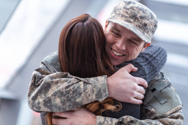 istock Man hugging his wife after returning home from service 1136917506