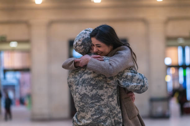 istock Woman hugging her partner after returning home from service 1136917514