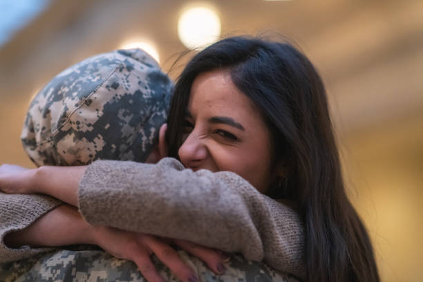 istock Woman hugging her husband after returning home from service 1136917529