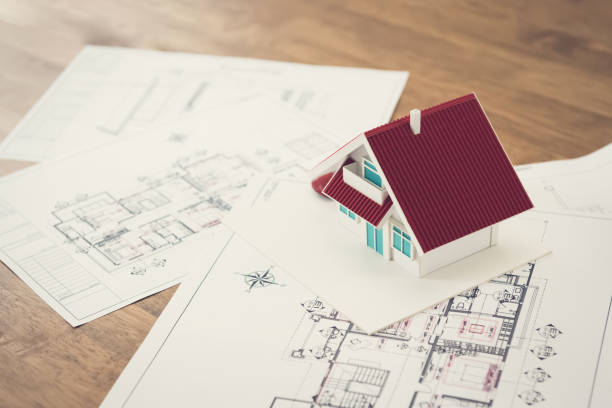 istock Blueprints and house model on the table 1136917677