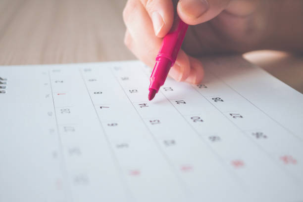 istock Hand with pen writing on calendar page closeup 1136917719