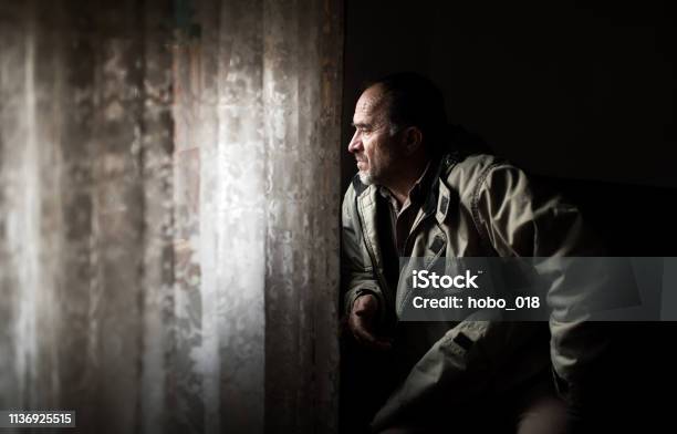 Middle Age Man Looking Through Window Stock Photo - Download Image Now - Depression - Sadness, Looking Through Window, Mature Men