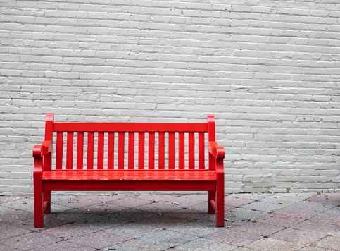 red bench in an alleyway