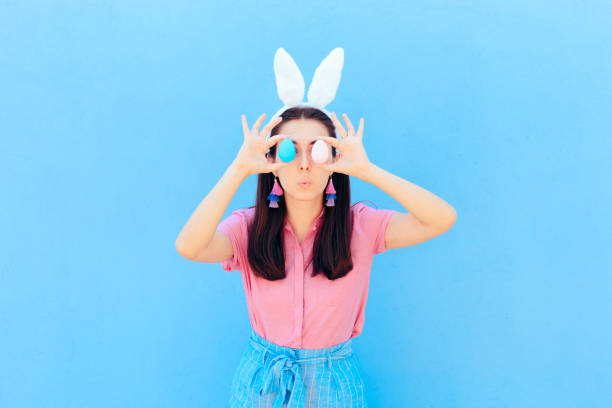istock Funny Girl with Bunny Ears Holding Easter Eggs 1136927393