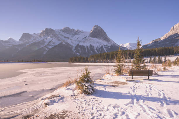 istock Bench in Rocky Mountains with Tracks in Snow 1136927435