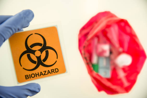 Disposal container; reducing medical waste disposal. Small Medical Waste sharps container with sharps for biohazand. stock photo