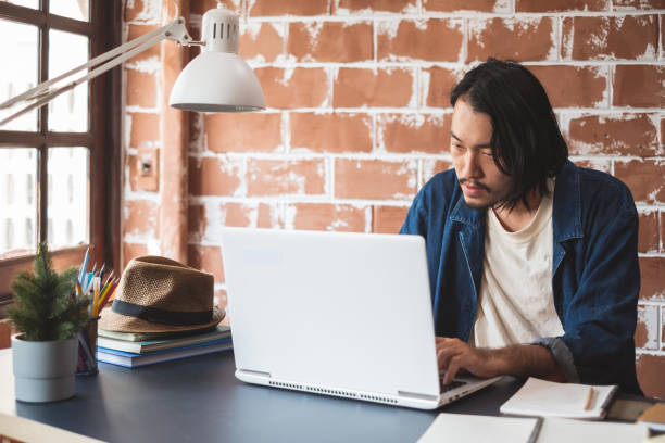 istock Young Asian man working on laptop for business creative designer 1136930280