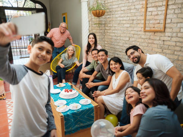 istock Mexican boy taking selfie with family 1136937781
