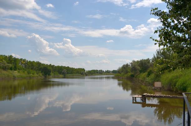 istock Summer lake water and the forest beautiful clouds 1136937908