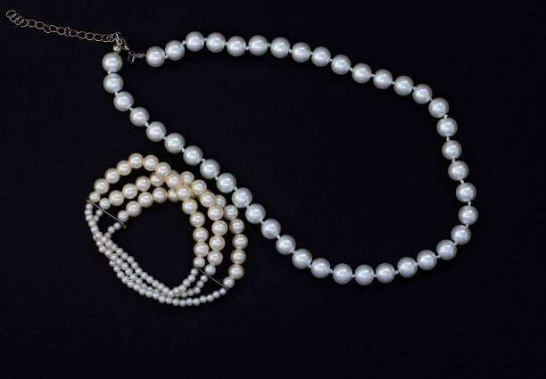 istock women's jewelry with pearls on black background 1136945290