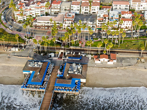 Aerial view of San Clemente Pier with beach and coastline before sunset time. San Clemente city in Orange County, California, USA. Travel destination in the South West Coast. Famous beach for surfer.