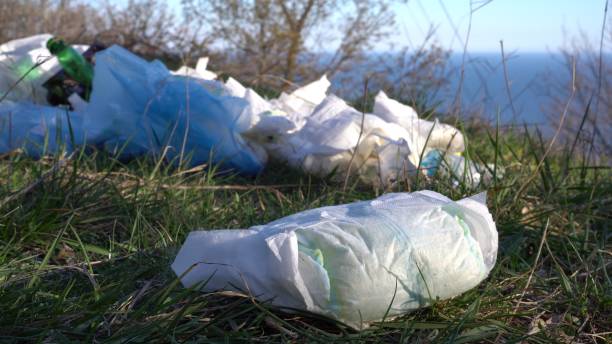 Dirty nappies a major contributor to waste dumped in public places. The Problem To The Environment Disposable diaper waste in landfill. Environmental pollution contributor stock pictures, royalty-free photos & images