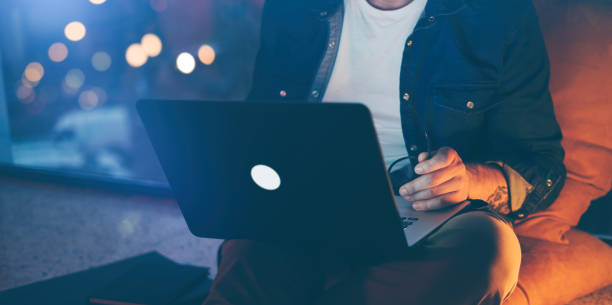 istock Man working on laptop at night 1136948350
