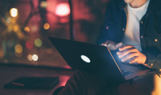 Man working on laptop at night