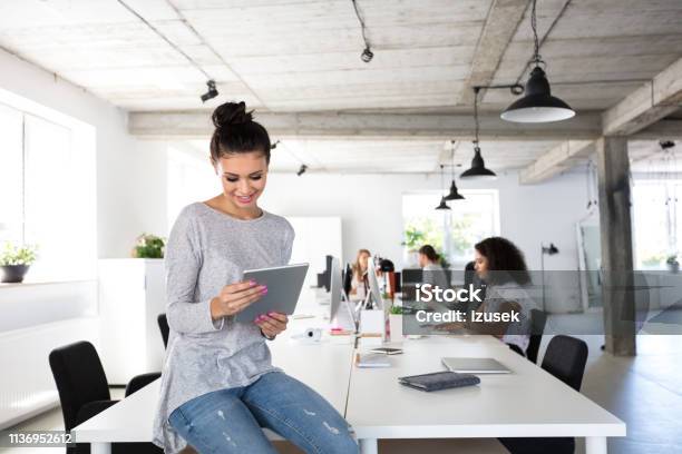 Beautiful Young Woman With Digital Tablet At Office Stock Photo - Download Image Now