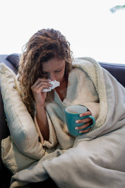 istock Woman sneezing from the flu 1136953505