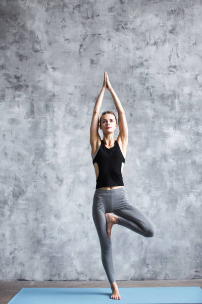 istock Yoga woman tree pose. 1136956684