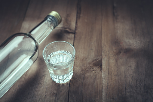 Vodka on a wood background.
