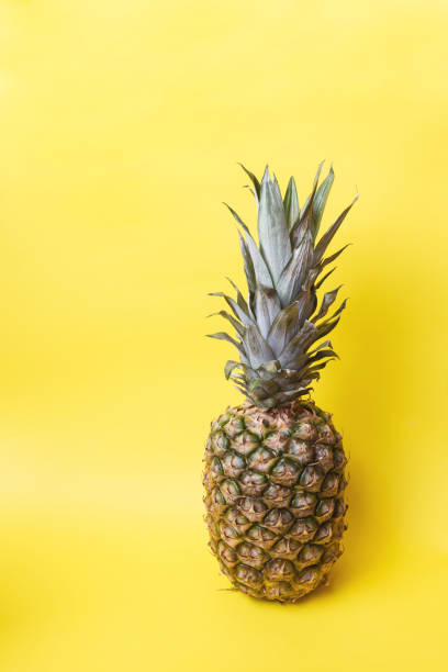 istock Ripe pineapple on a yellow toned background 1136957624