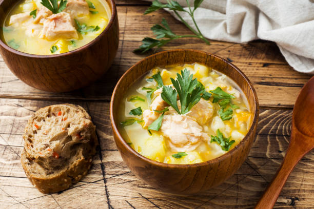 istock Fish soup in a wooden bowl with fresh herbs. 1136957797