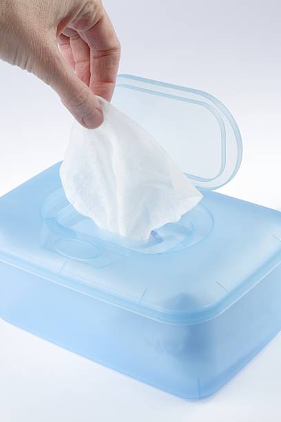 istock Fingers grabbing tissue out of blue tissue box  113696230