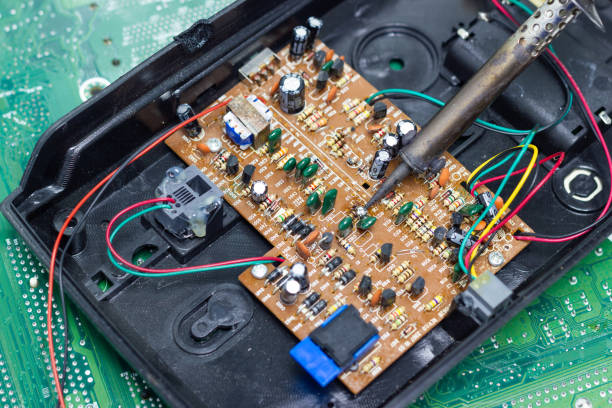 istock Technician repairing electronic of the computer circuit board by soldering Irons 1136962452