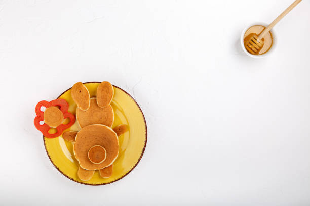 Funny bunny pancakes in yellow plate on white background. Creative breakfast for kids, Easter pancakes. Top view, copy space. Funny bunny pancakes in yellow plate on white background. Creative breakfast for kids, Easter pancakes. Top view, copy space. bunny pancake stock pictures, royalty-free photos & images