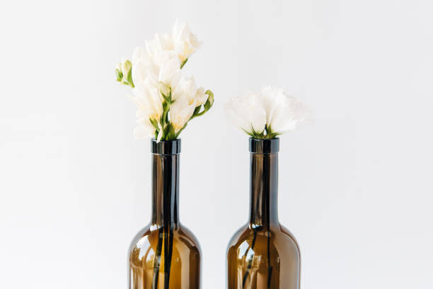 istock light bouquet in bottles.minimal composition of beautiful white flowers.copy space.white background. 1136967546