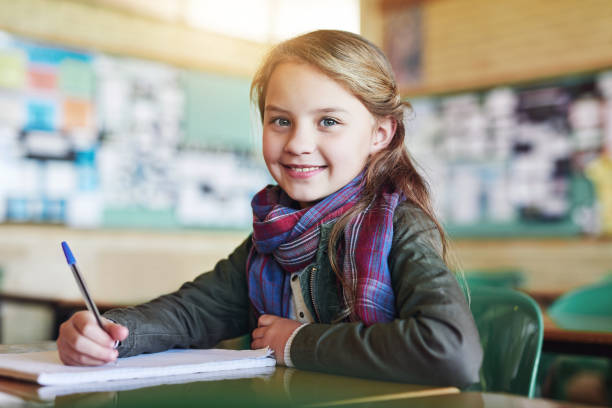 You can see she's ready to write the test Shot of an adorable little girl doing her school work in class one girl only stock pictures, royalty-free photos & images