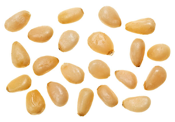Unshelled pine nuts isolated on white, food background stock photo