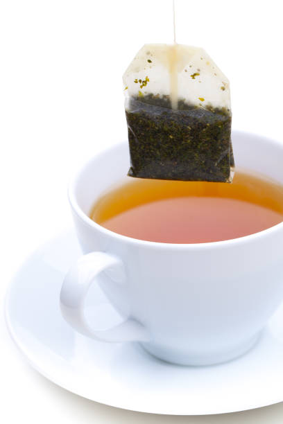 istock Black tea in the bag over cup isolated on white background 1136969685