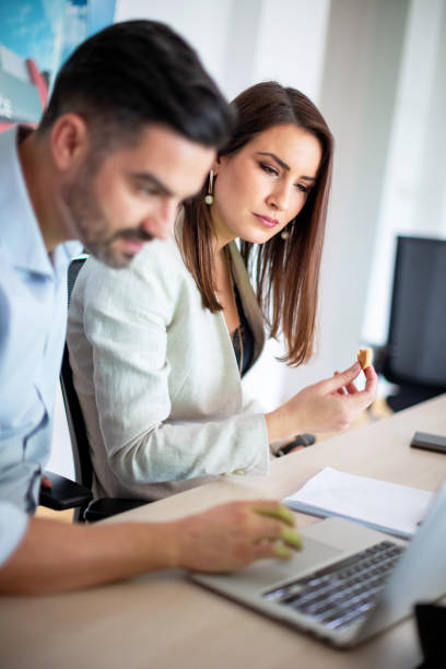 istock Coworkers looking at laptop on a meeting 1136971302