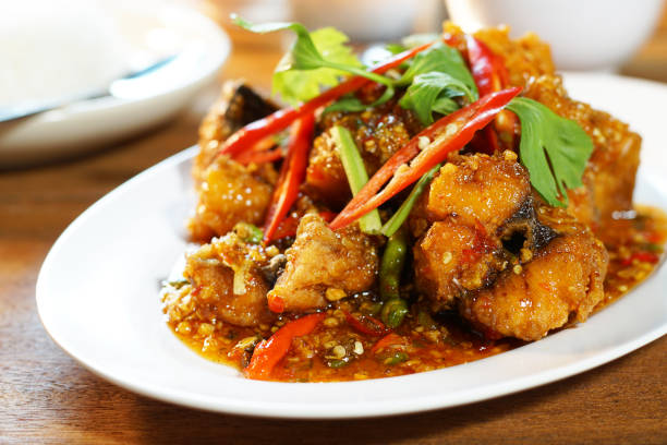 Fried fish with sweet chilli sauce served with steamed rice, Selective focus. Still life shoot in studio, Clean food good taste idea concept.
