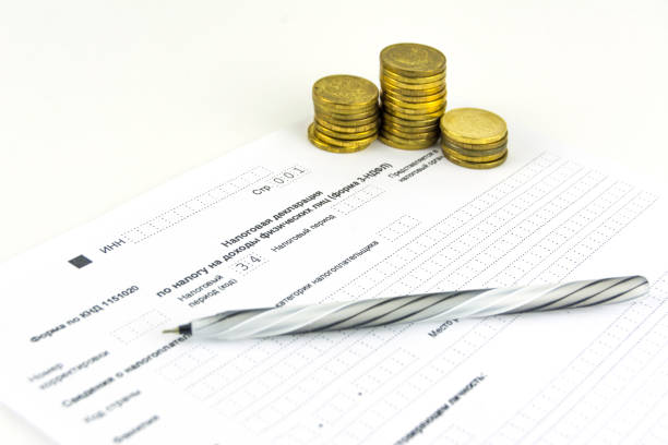 istock Russian documents. 3-NDFL tax return form. Pen and coins 1136972291