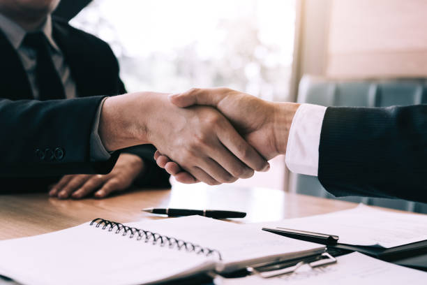 istock Manager and employee interview concept with handshake after talking about contract signing. 1136972695