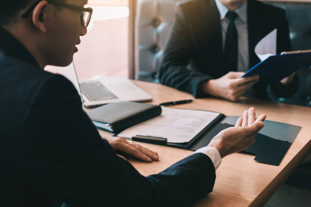 istock Male employee is explaining to the manager while being interviewed in the office room. 1136972742
