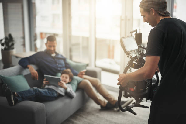 You guys are doing great! Behind the scenes shot of a camera operator shooting a scene with a state of the art camera inside of a studio during the day crew photos stock pictures, royalty-free photos & images