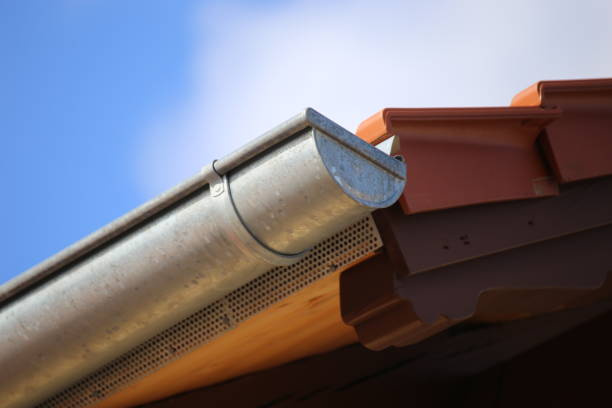 istock Roof gutter on a new tiled roof 1136974253