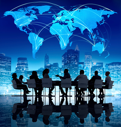 Silhouette of people in a meeting with a world map