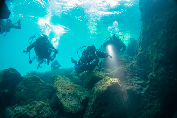 istock Scuba divers in cave diving 1136975443