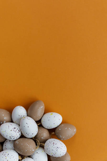 istock Easter decor. Decorative eggs are laid out on an orange background 1136975494
