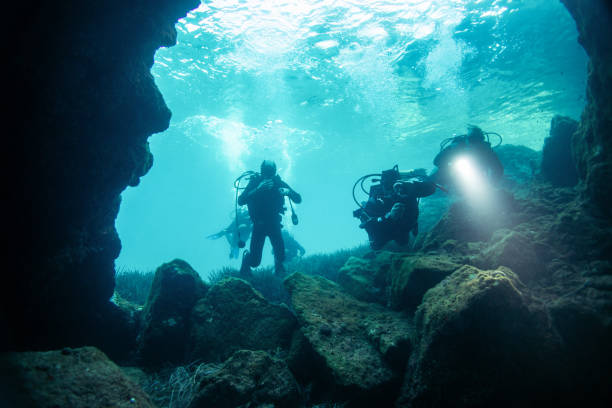 istock Scuba divers in cave diving 1136975630