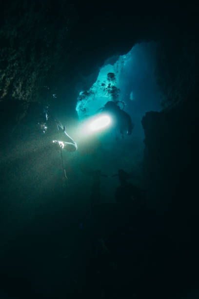 istock Scuba divers in cave diving 1136975632