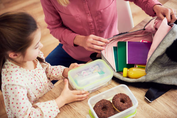 istock Mother and child packing backpack for the school 1136976216