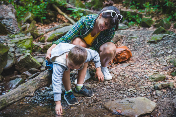 istock mother with kid near mountains river 1136978570