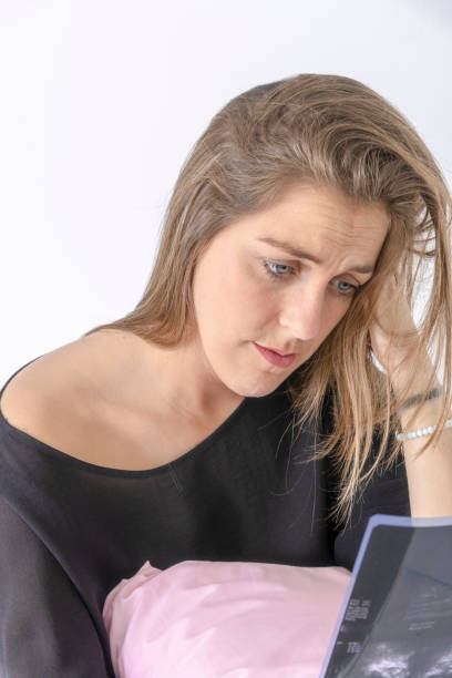istock young woman looking at X-rays in a white background 1136984869